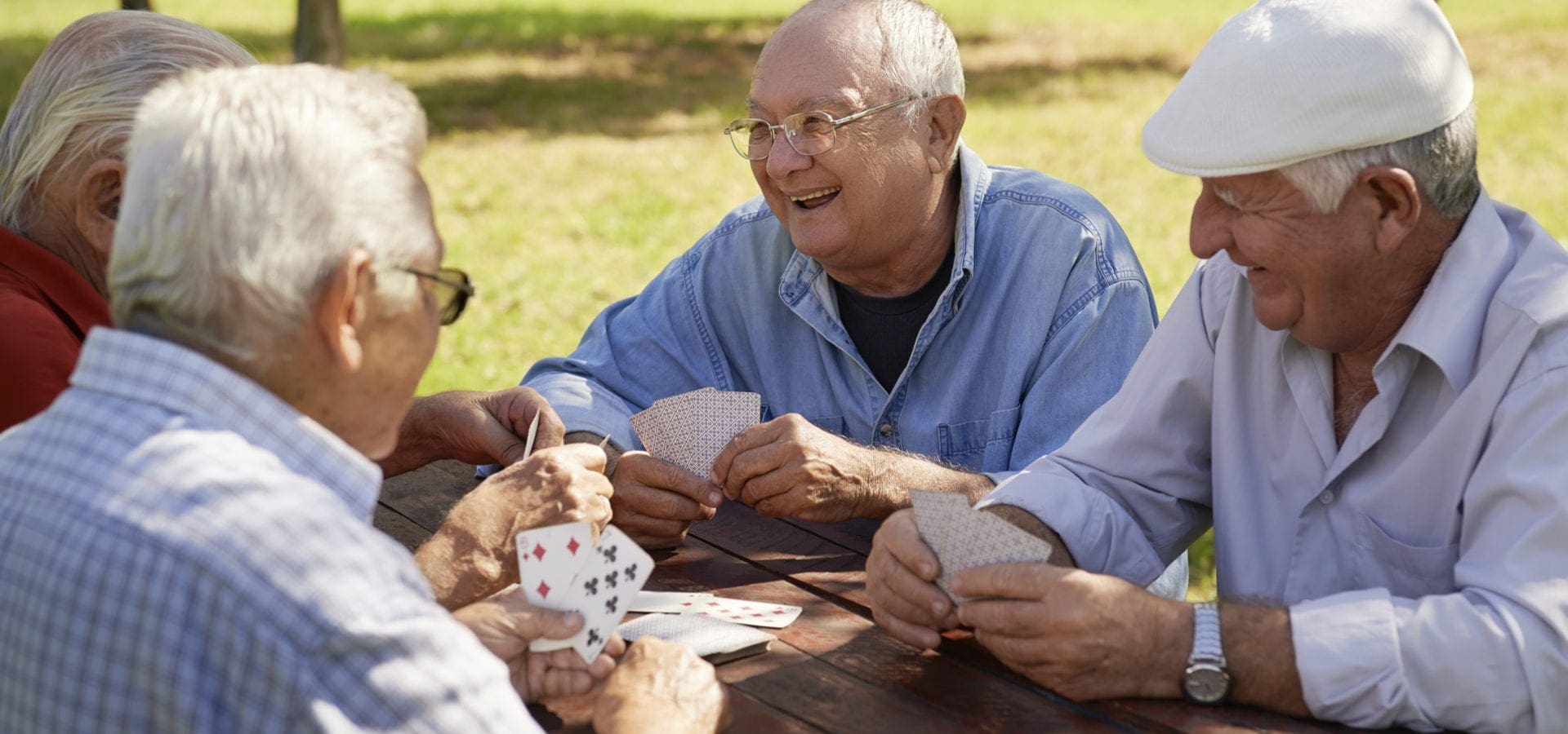 Seniors playing a card game to keep their brain active